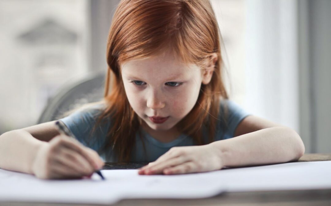 Child with red hair writing