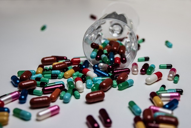 Pills around a fallen glass with more pills inside