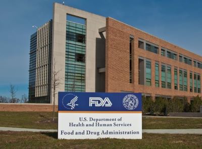 Brown and grey building with FDA sign in front of it.