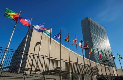 United Nations building with flags of various countries in front of it