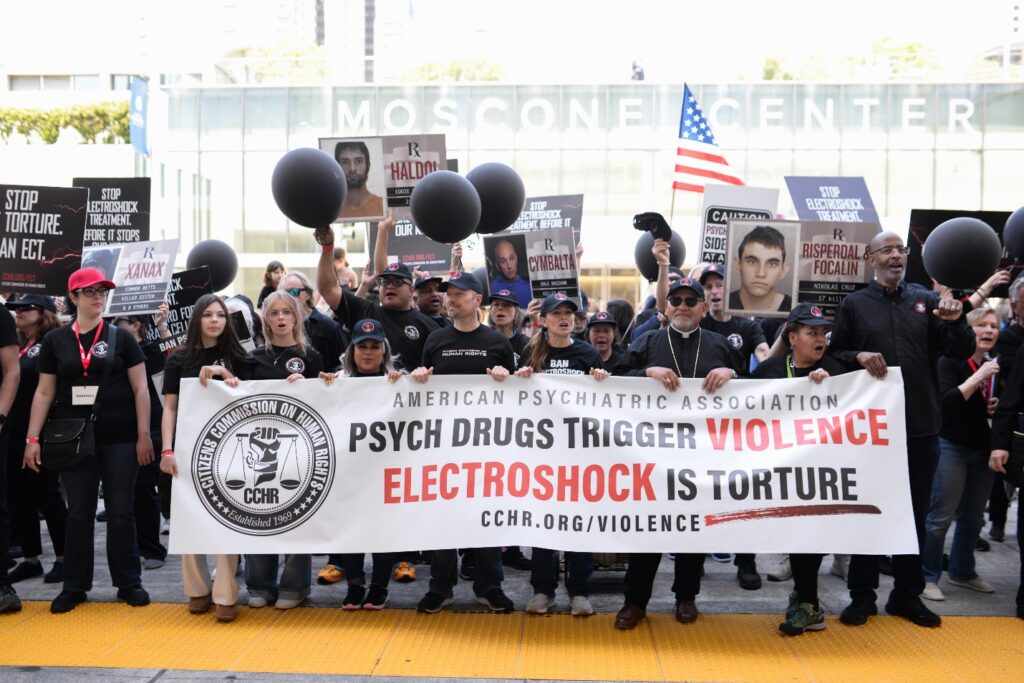 Protesters with a banner: Psychiatric Drugs Trigger Violence - Electroshock is Torture